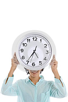 Hipanic woman holding big clock on her face