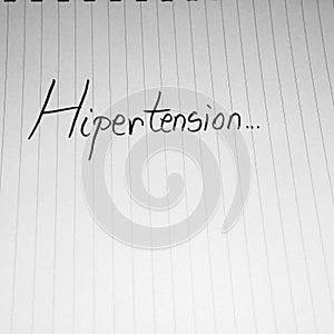 Hipertension handwriting  text on paper, on office agenda. Copy space photo