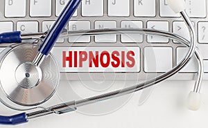 HIPNOSIS text on keyboard with stethoscope , medical concept photo