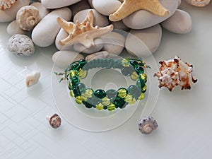 Hippie colorful bracelet on sea stones background