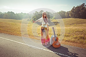 Hippie girl hitchhiking