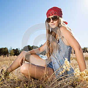 Hippie girl sitting on a meadow - morning outdoors shot