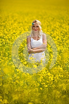 Hippie girl standing in yellow field