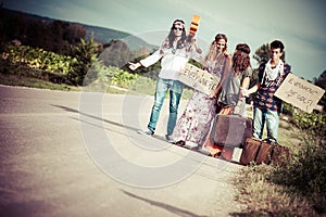 Hippie Group Hitchhiking on a Countryside Road
