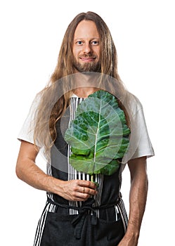 Hippie man holding a kale leaf over his heart