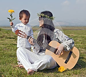 Hippie Woman playing Guitar with Son