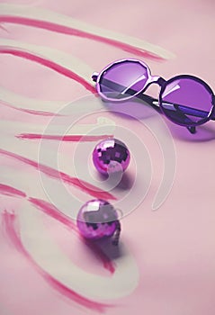 Hippy sixties sunglasses and disco balls on love background