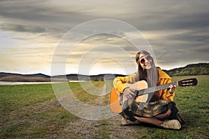 Hippy teenager playing the guitar photo