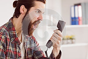 Hipster angry businessman making a call