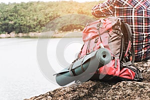 Hipster asian young girl with backpack enjoying sunset on peak mountain. Travel Lifestyle adventure concept