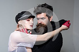 Hipster with beard and girl in leather cap and gloves. couple in love of woman and bearded man. rock couple embrace