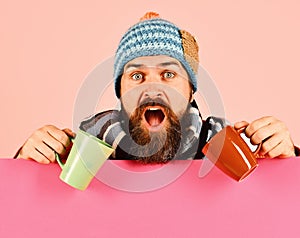 Hipster with beard and shocked face has fragrant coffee