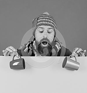 Hipster with beard and surprised face has coffee