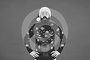 Hipster bearded man wear winter sweater and hat red background. Holly jolly christmas. Happy new year. Join holiday
