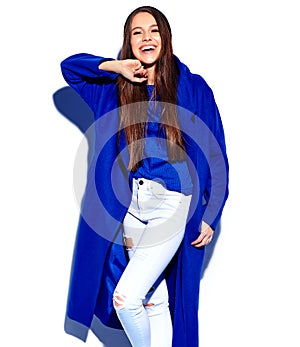 Hipster brunette woman model in stylish blue overcoat isolated on white