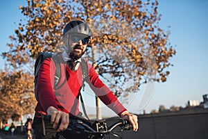 Hipster businessman commuter with bicycle traveling to work in city.