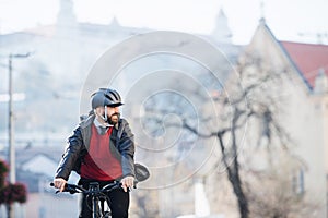 Hipster businessman commuter with bicycle traveling to work in city.