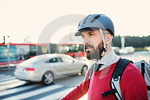 Hipster businessman commuter with bicycle traveling to work in city.