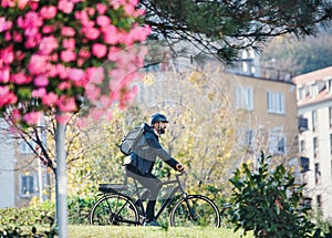 Hipster businessman commuter with bicycle traveling to work in city.