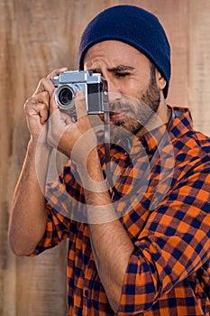 Hipster businessman photographing through camera