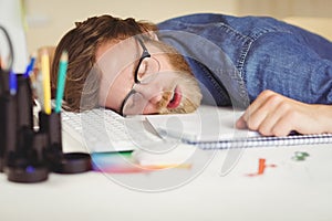 Hipster businessman sleeping at his desk