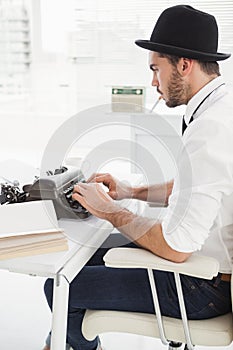 Hipster businessman using a typewriter