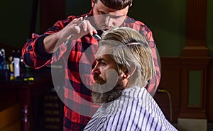 Hipster client getting haircut. Barber scissors. Manage your expectations. Cut hair. Barber making hairstyle for bearded