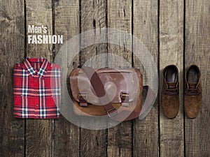 Hipster clothes and accessories on a wooden background