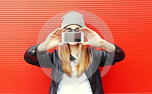 Hipster cool girl taking picture on smartphone self-portrait