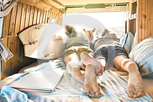 Hipster couple with cute dog traveling together on vintage mini van