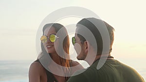 Hipster couple on motorcycle on sea coastal road in the sunset