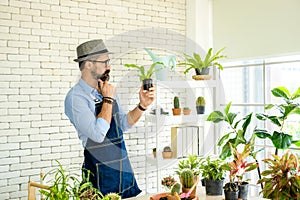 Hipster elderly men take care of the trees, a hobby of urban home gardening after sustainable retirement