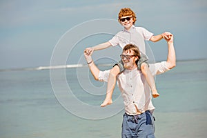 Hipster father with beard and red haired son