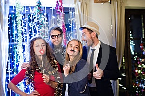 Hipster friends celebrating New Years Eve together, photobooth p