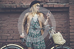 Hipster girl with bike and phone