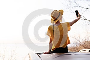 Hipster Girl Blogger on Car Sunroof Make Selfie