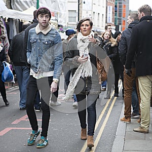 The hipster girl and boy dressed in cool Londoner style walking in Brick lane, a street popular among young trendy people