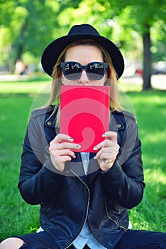 Hipster girl covering her face book