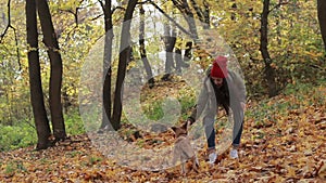 Hipster girl and dog enjoying in autumn park