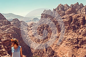 Hipster girl enjoy vacation and journey to Jordan. Gorgeous view from Petra. Negative space for text. Tourism industry. Active lif