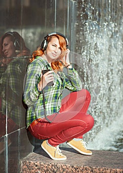 Hipster girl with headphones listening music