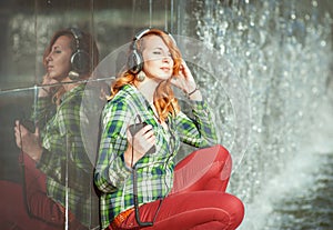 Hipster girl with headphones listening music