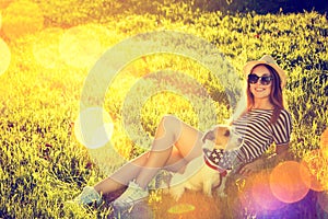 Hipster Girl with her Dog Lying on the Grass