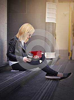 Hipster girl reading a red book