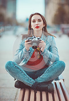 Hipster girl with retro camera