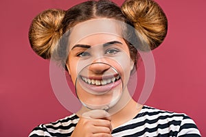 Hipster girl showing teeth through a magnifying glass isolated