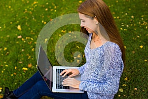 Hipster girl skilled blogger keyboarding on netbook