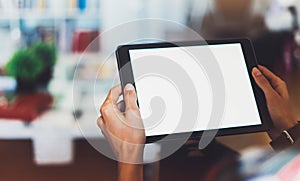 Hipster girl using tablet technology in home atmosphere, girl person holding computer with blank screen on background bokeh, femal