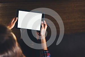 Hipster girl using tablet technology in home atmosphere, girl person holding computer with blank screen on background bokeh, femal