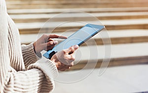 Hipster girl using tablet technology internet, blogger person holding computer on background sun city, female hands texting online